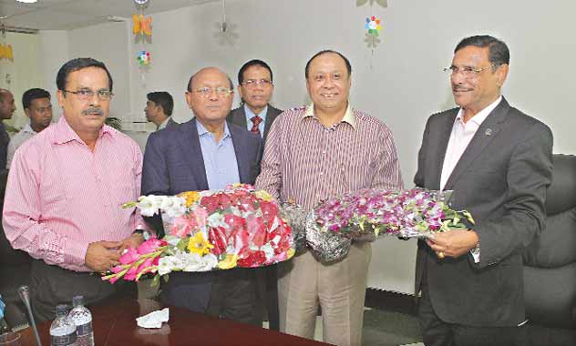 Commerce Minister Tofail Ahmed and Communications Minister Obaidul Quader present bouquets to Ahmed Akbar Sobhan, chairman of the East-West Media Group Ltd, on the occasion of the 4th anniversary of publication of Bangladesh Pratidin at EWMGL conference room in Bashundhara residential area in the city on Saturday.
